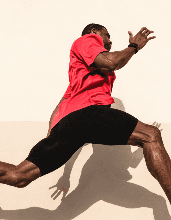 Man wearing athletic gear jumping forward